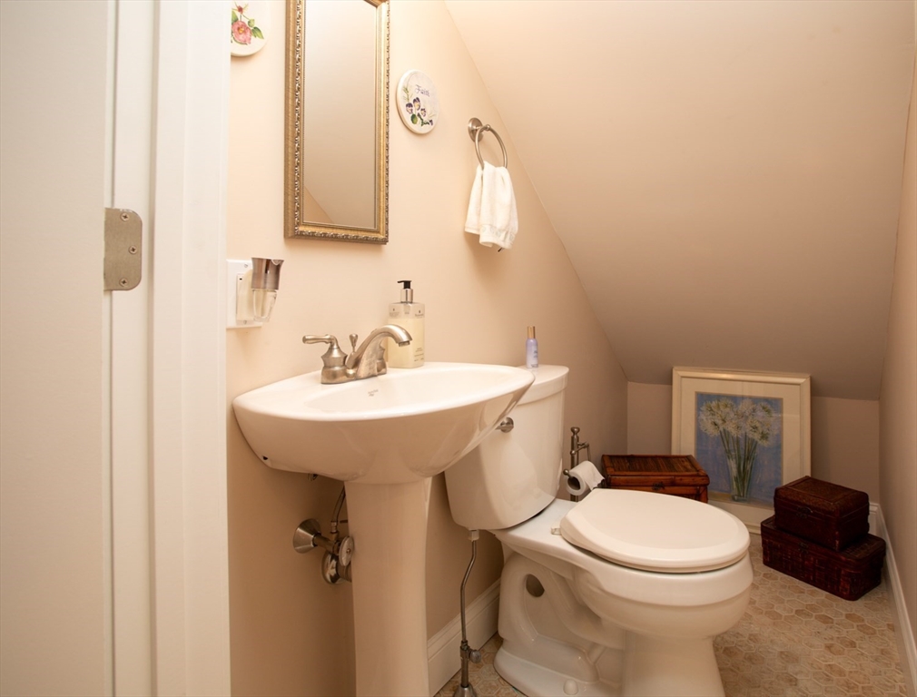 1346 Main Road, Unit B Westport, MA 02790 - Photo 21 of 29 a white toilet sitting next to a bathroom sink