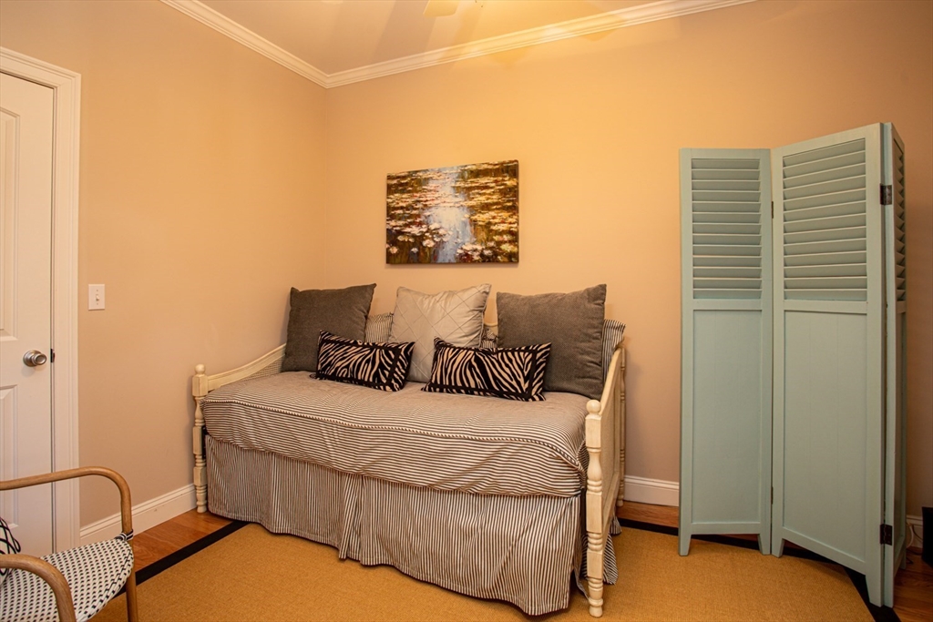1346 Main Road, Unit B Westport, MA 02790 - Photo 22 of 29 a bedroom with a bed and a night stand