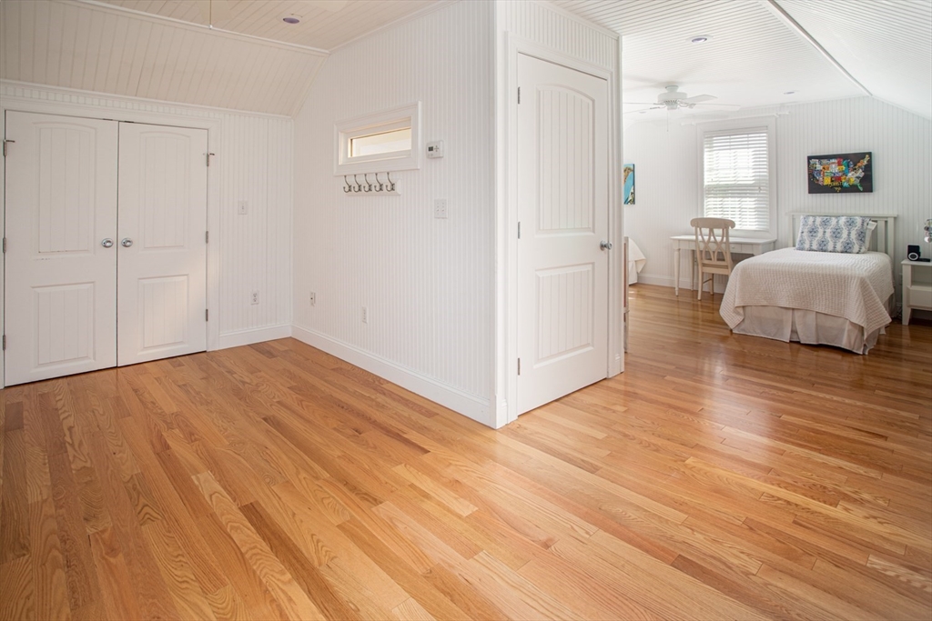 1346 Main Road, Unit B Westport, MA 02790 - Photo 26 of 29 a view of a bedroom with wooden floor and furniture