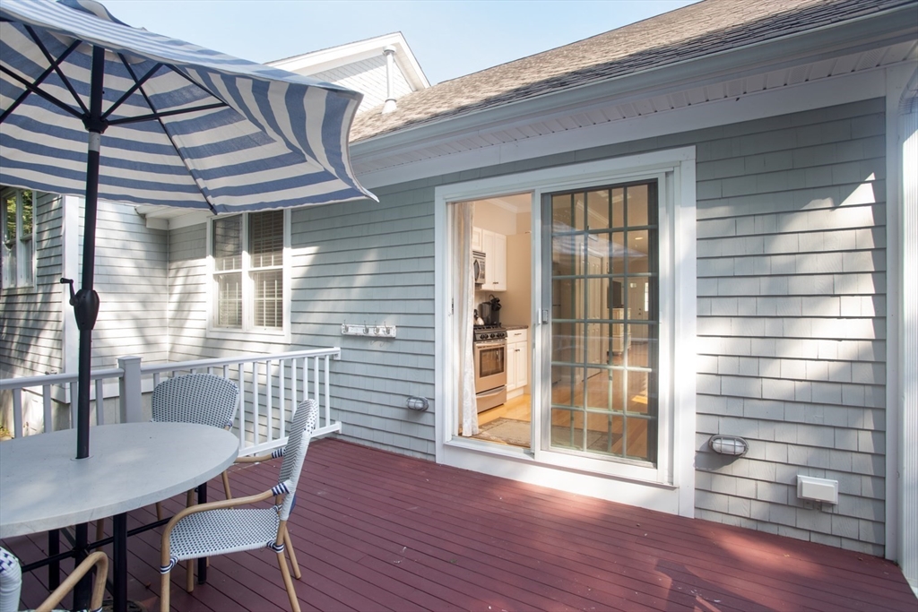 1346 Main Road, Unit B Westport, MA 02790 - Photo 27 of 29 a view of a deck with table and chairs and wooden floor