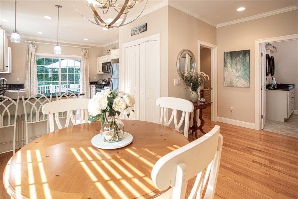 1346 Main Road, Unit B Westport, MA 02790 - Photo 9 of 29 a view of a dining room with furniture a chandelier and wooden floor