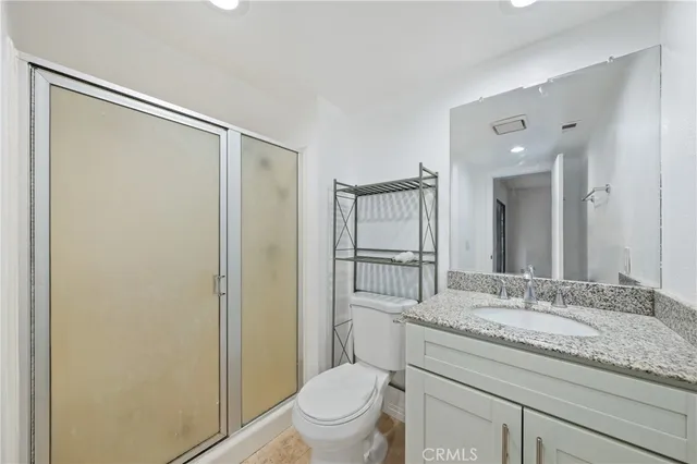 a bedroom with a bed couch and window