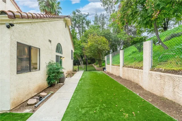 a view of a house with a yard and a patio