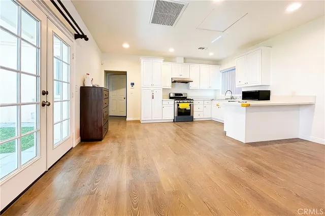 a kitchen with cabinets appliances and a window