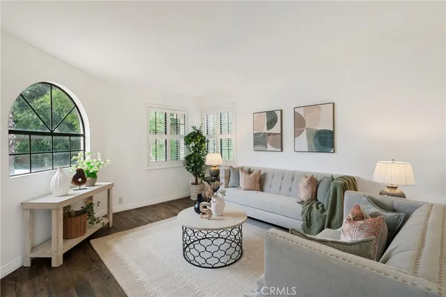 a living room with furniture a rug and a window