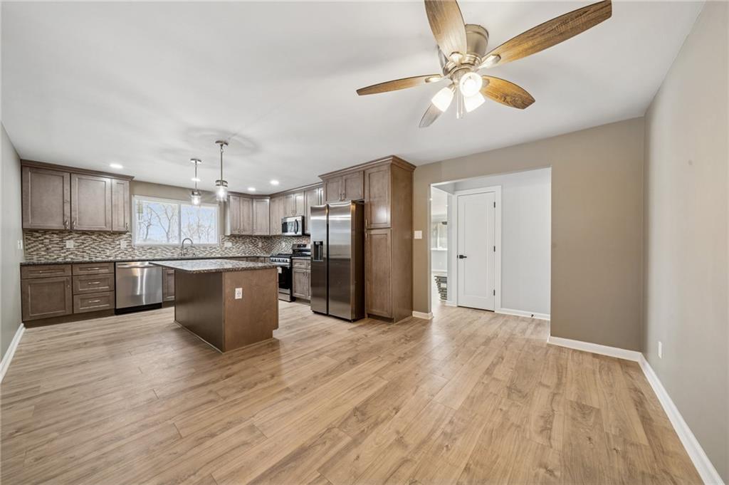 12305 Larimer Avenue Irwin, PA 15642 - Photo 3 of 39 COMBINED KITCHEN/DINING ROOM. NEW KITCHEN CABINETS, GRANITE COUNTERTOPS, AND LARGE KITCHEN ISLAND