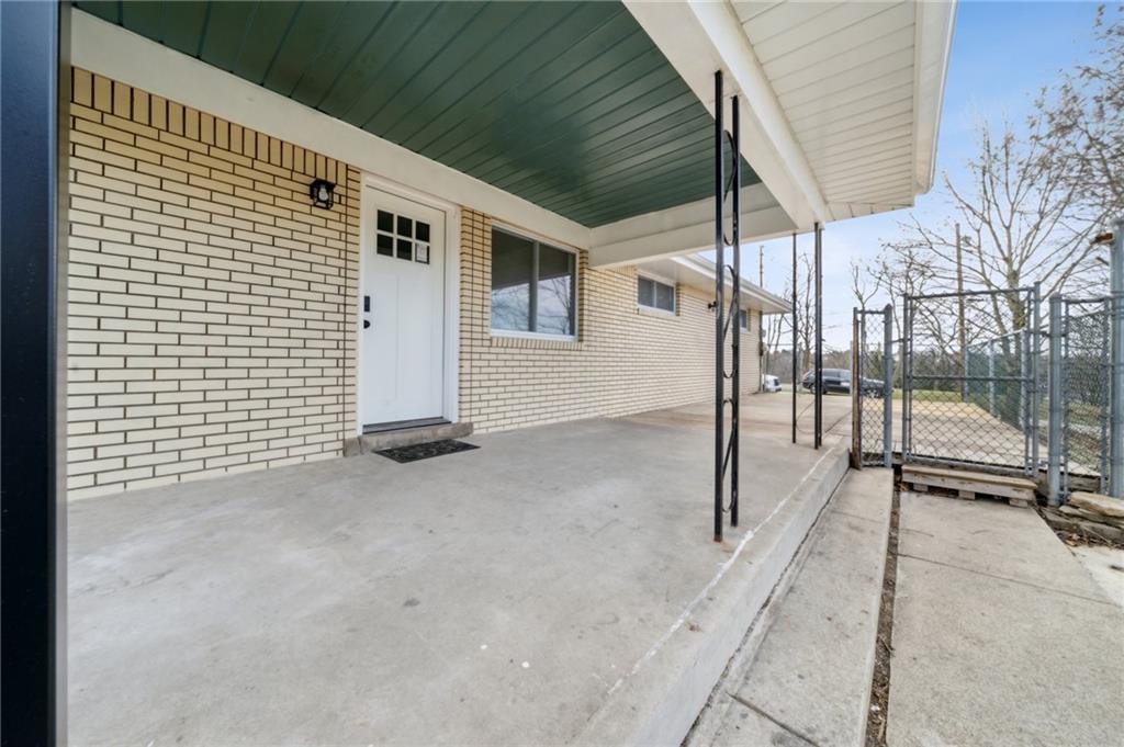 12305 Larimer Avenue Irwin, PA 15642 - Photo 32 of 39 COVERED PORCH. EASY ACCESS FROM OFF STREET PARKING AREA TO MAIN LEVEL.