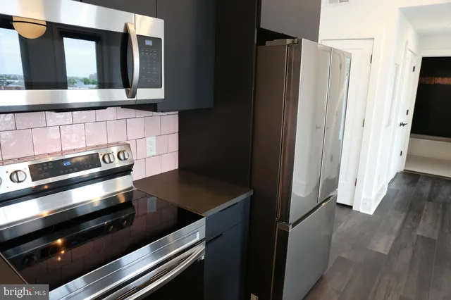 a kitchen with appliances and cabinets