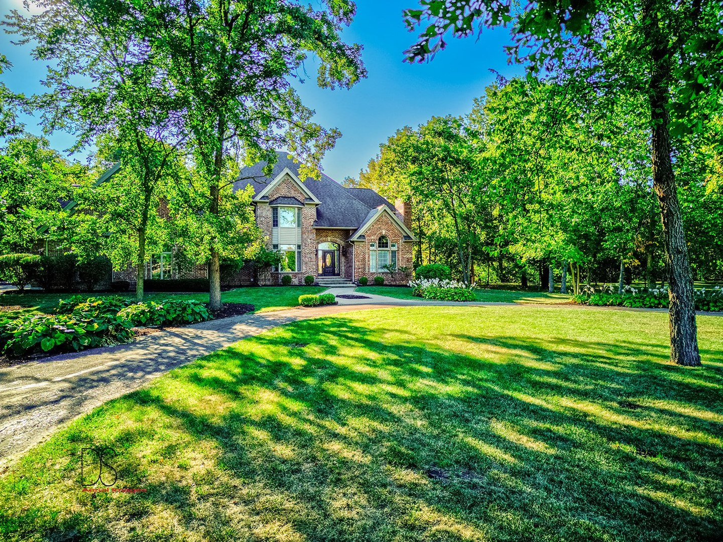 a front view of house with yard and green space