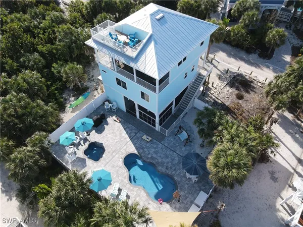 a aerial view of a house with yard and sitting area