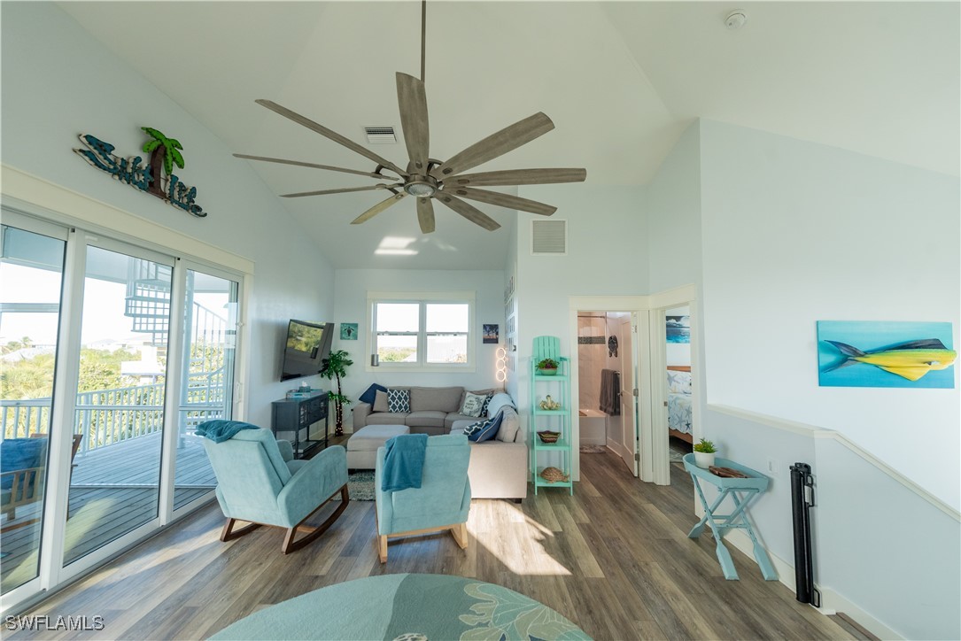 4500 Butterfly Shell Drive Captiva, FL 33924 - Photo 11 of 42 a living room with furniture a ceiling fan and a floor to ceiling window
