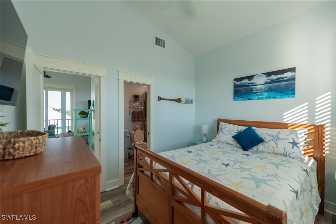 4500 Butterfly Shell Drive Captiva, FL 33924 - Photo 13 of 42 a bedroom with a bed and wooden floor