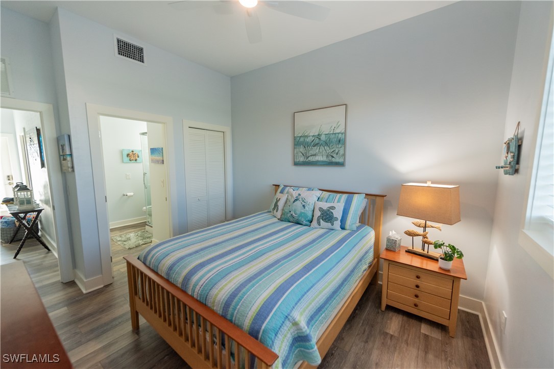 4500 Butterfly Shell Drive Captiva, FL 33924 - Photo 15 of 42 a bedroom with a bed and wooden floor