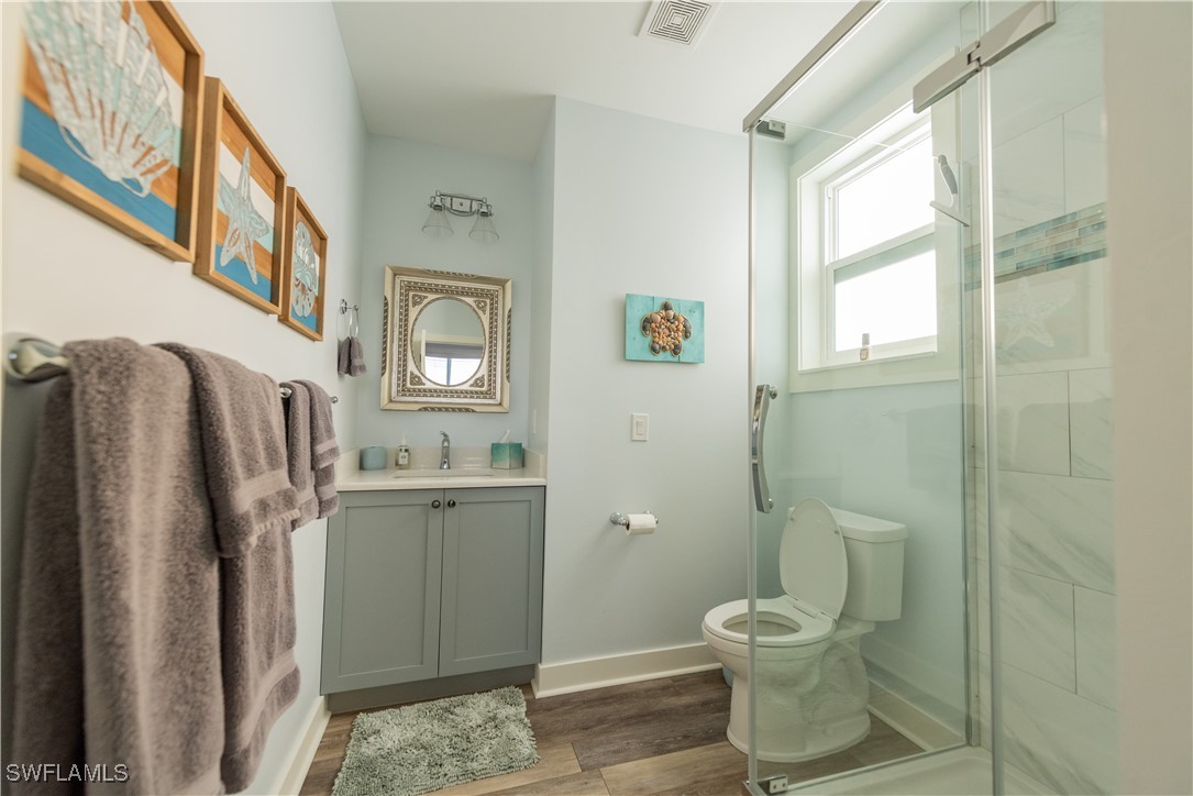 4500 Butterfly Shell Drive Captiva, FL 33924 - Photo 16 of 42 a bathroom with a granite countertop toilet sink and shower