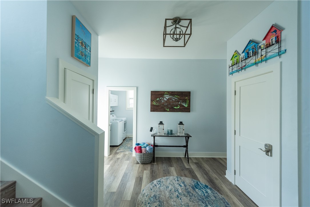 4500 Butterfly Shell Drive Captiva, FL 33924 - Photo 20 of 42 a view of a hallway with wooden floor and furniture