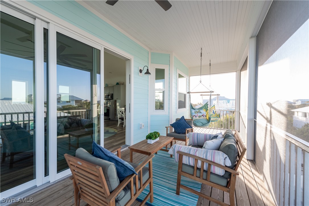 4500 Butterfly Shell Drive Captiva, FL 33924 - Photo 23 of 42 a living room with furniture and a floor to ceiling window