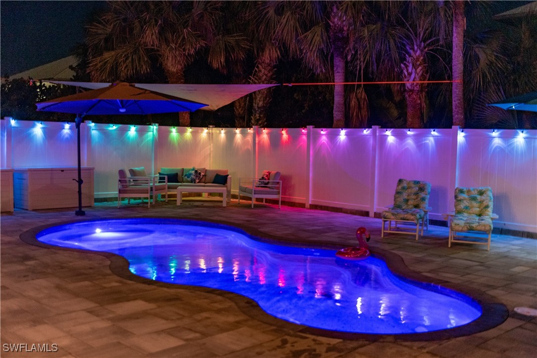 4500 Butterfly Shell Drive Captiva, FL 33924 - Photo 25 of 42 a view of a pool with red umbrella