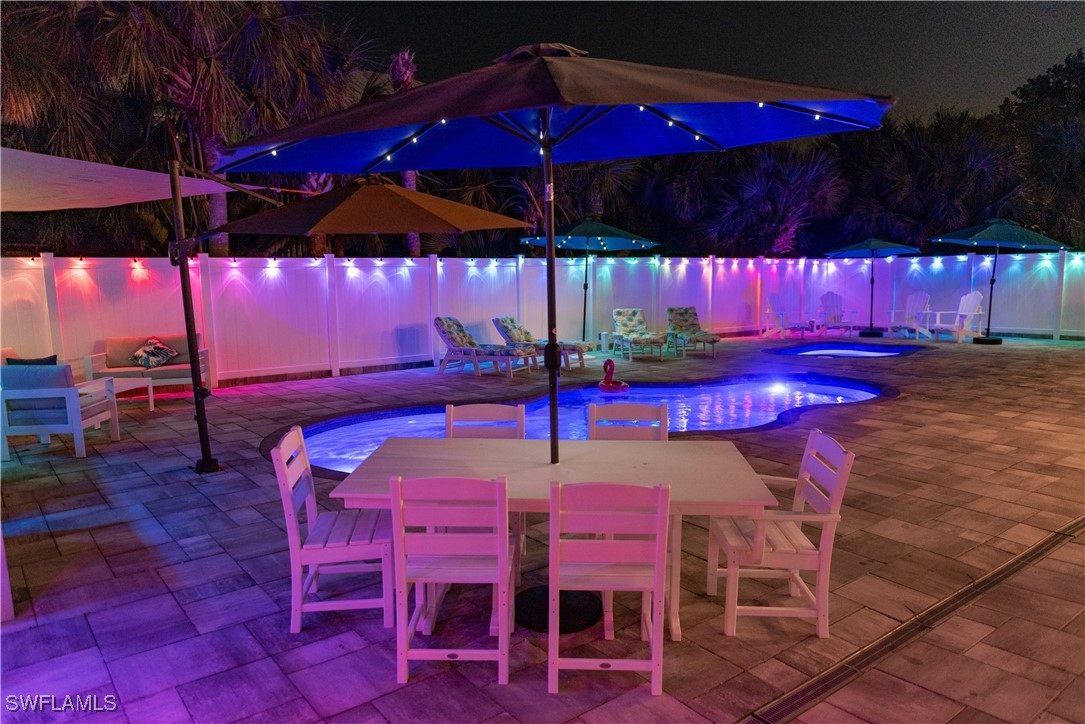 4500 Butterfly Shell Drive Captiva, FL 33924 - Photo 27 of 42 a view of a patio with table and chairs under an umbrella
