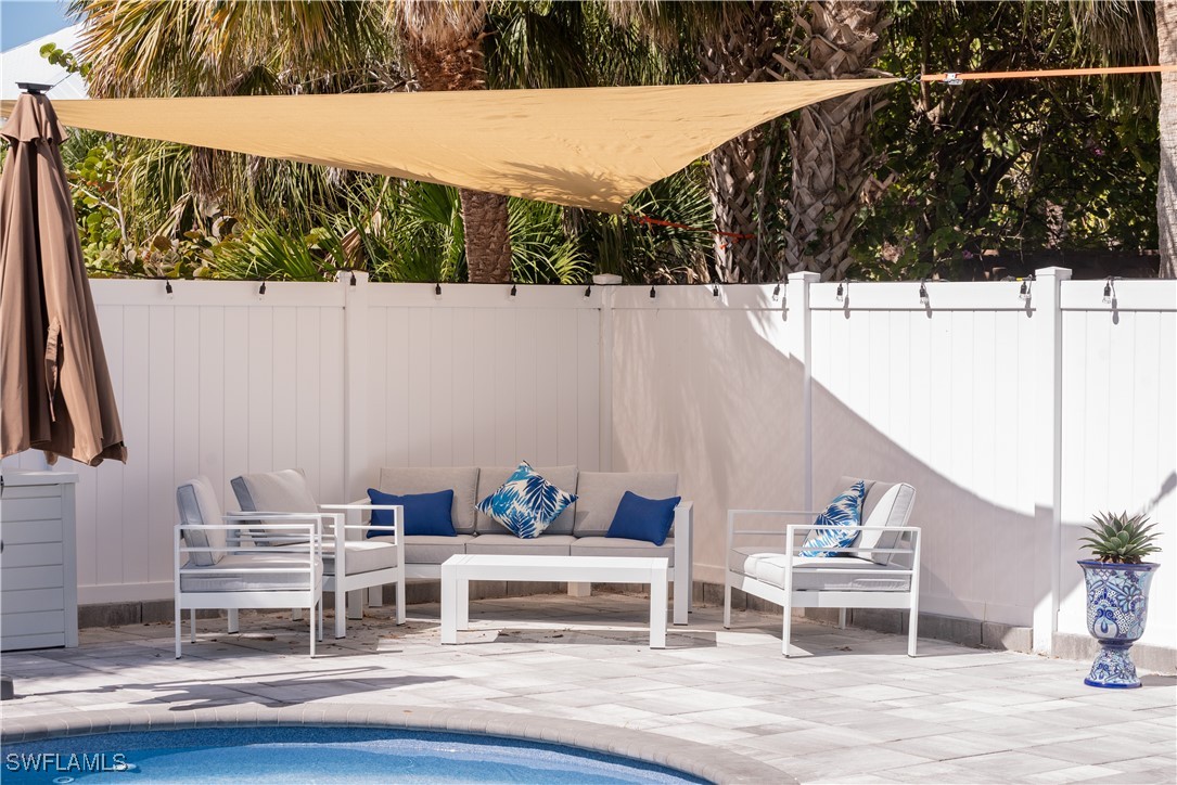 4500 Butterfly Shell Drive Captiva, FL 33924 - Photo 35 of 42 a backyard of a house with table and chairs