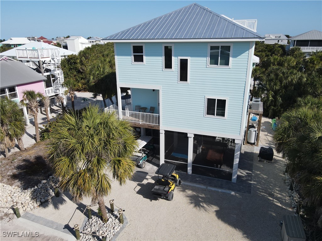 4500 Butterfly Shell Drive Captiva, FL 33924 - Photo 4 of 42 a view of house with yard and outdoor seating