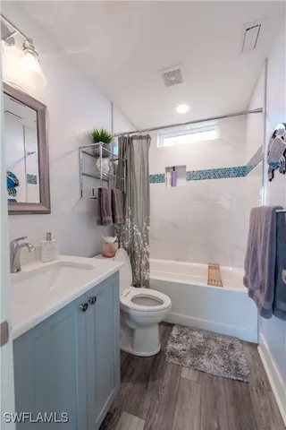 a living room with furniture a rug and a large window
