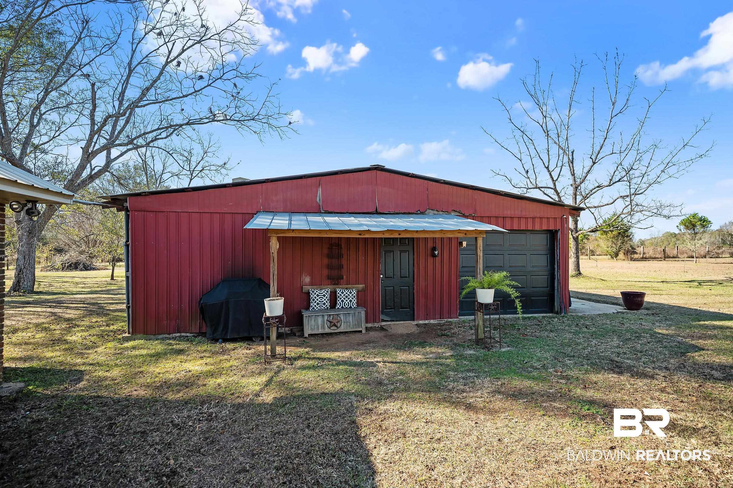 110 Sam Jones Road Atmore, AL 36502 - Photo 29 of 47 View of pole building featuring a lawn