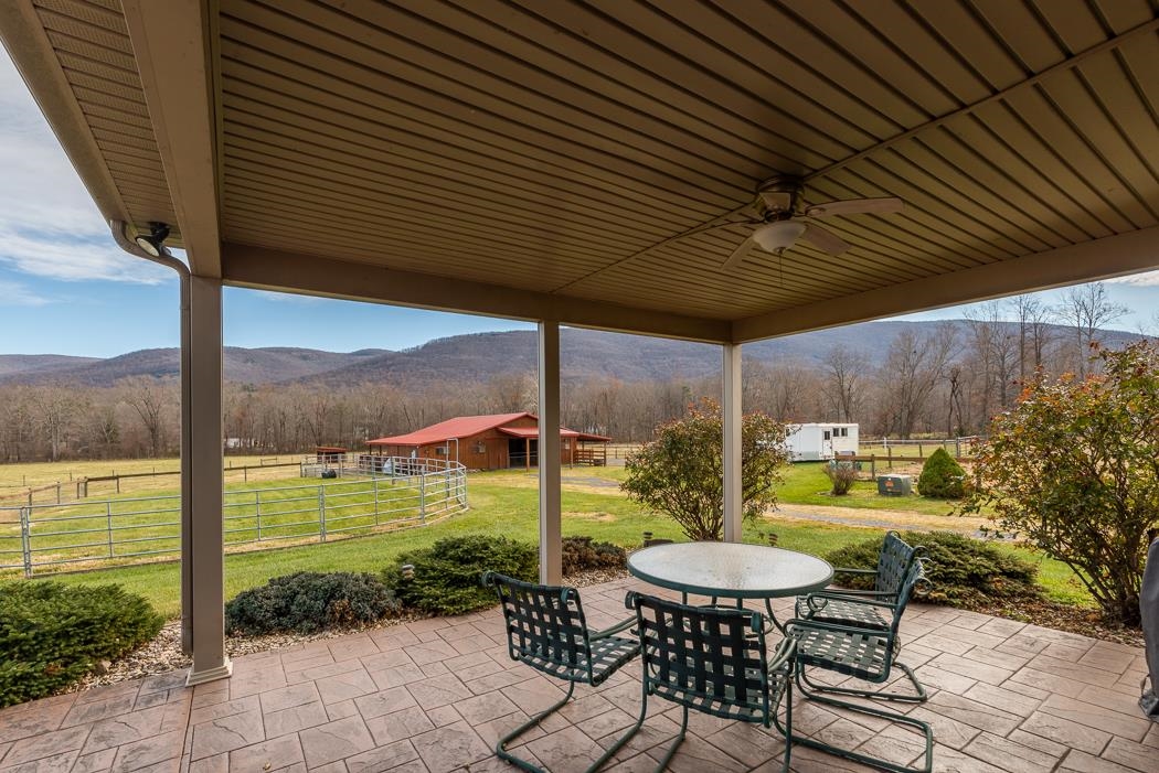 2564 Mt Torrey Road Lyndhurst, VA 22952 - Photo 7 of 64 a view of a table and chairs in patio with a barbeque grill