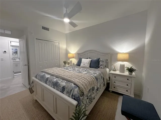 a bedroom with a bed and a lamp