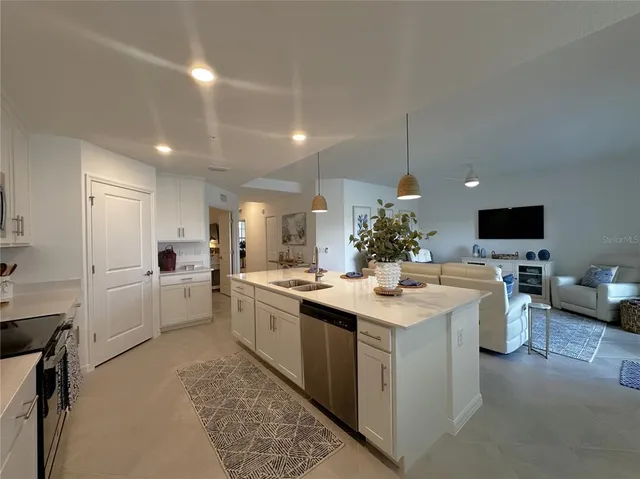 a kitchen with a sink stove and white cabinets