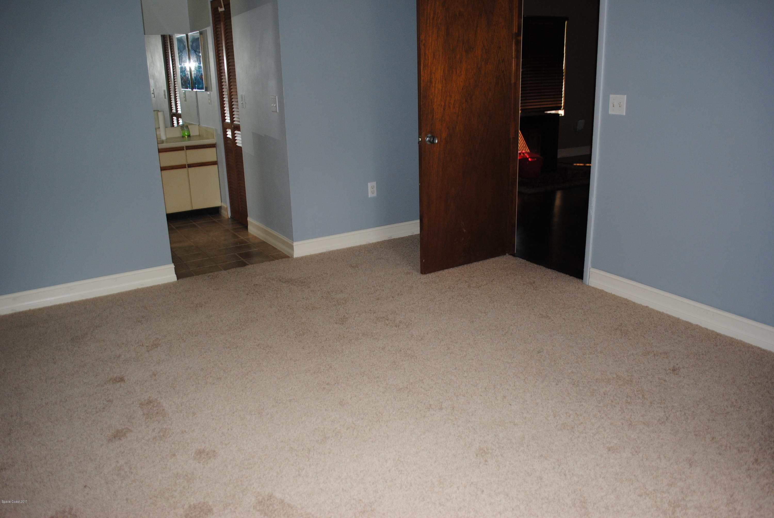 399 Warner Road Southwest Palm Bay, FL 32908 - Photo 12 of 40 an empty room with closet and windows