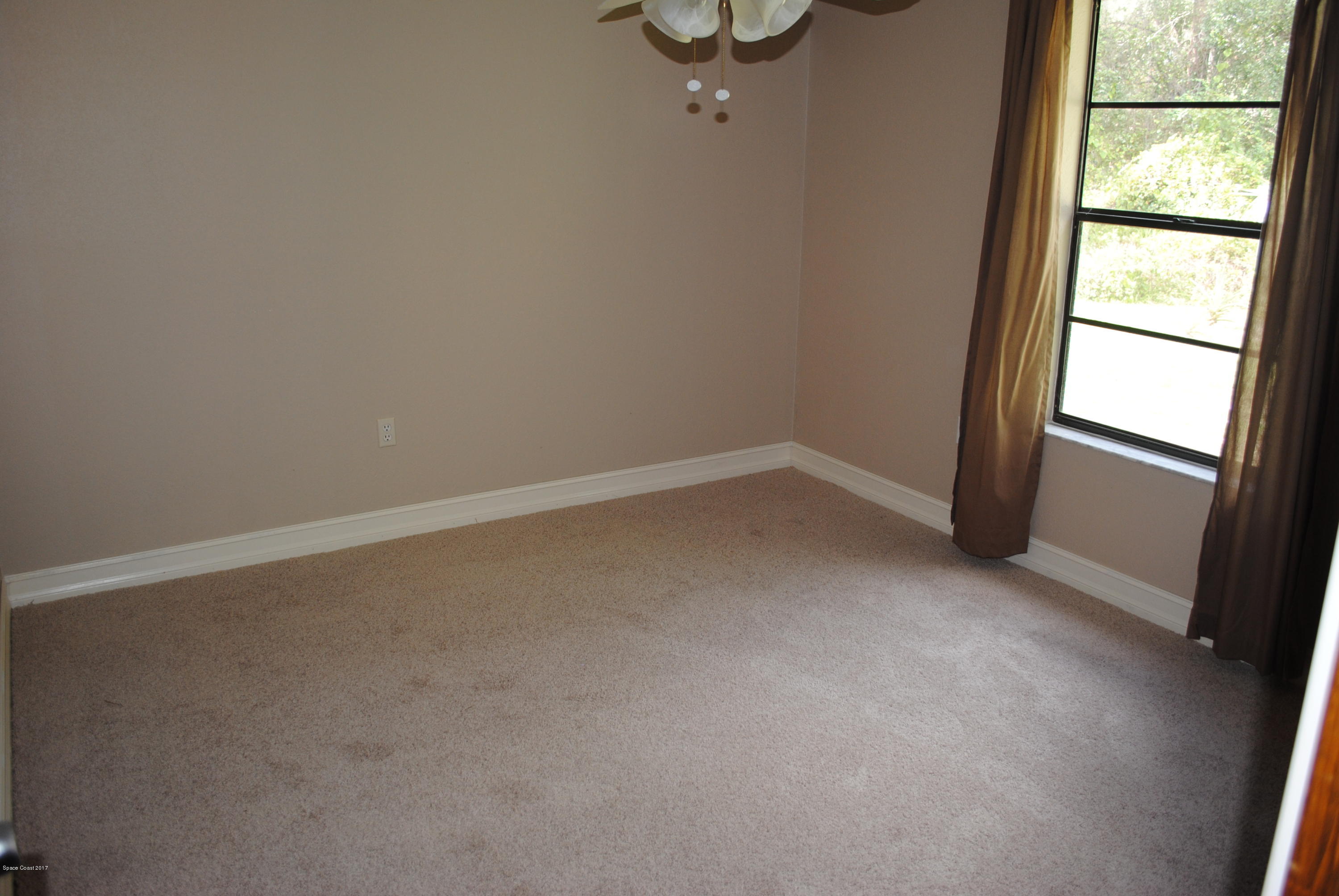 399 Warner Road Southwest Palm Bay, FL 32908 - Photo 17 of 40 a view of an empty room with a window