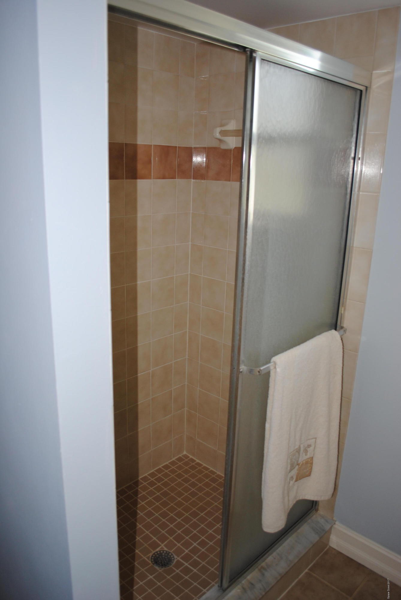 399 Warner Road Southwest Palm Bay, FL 32908 - Photo 26 of 40 a bathroom with a glass shower door