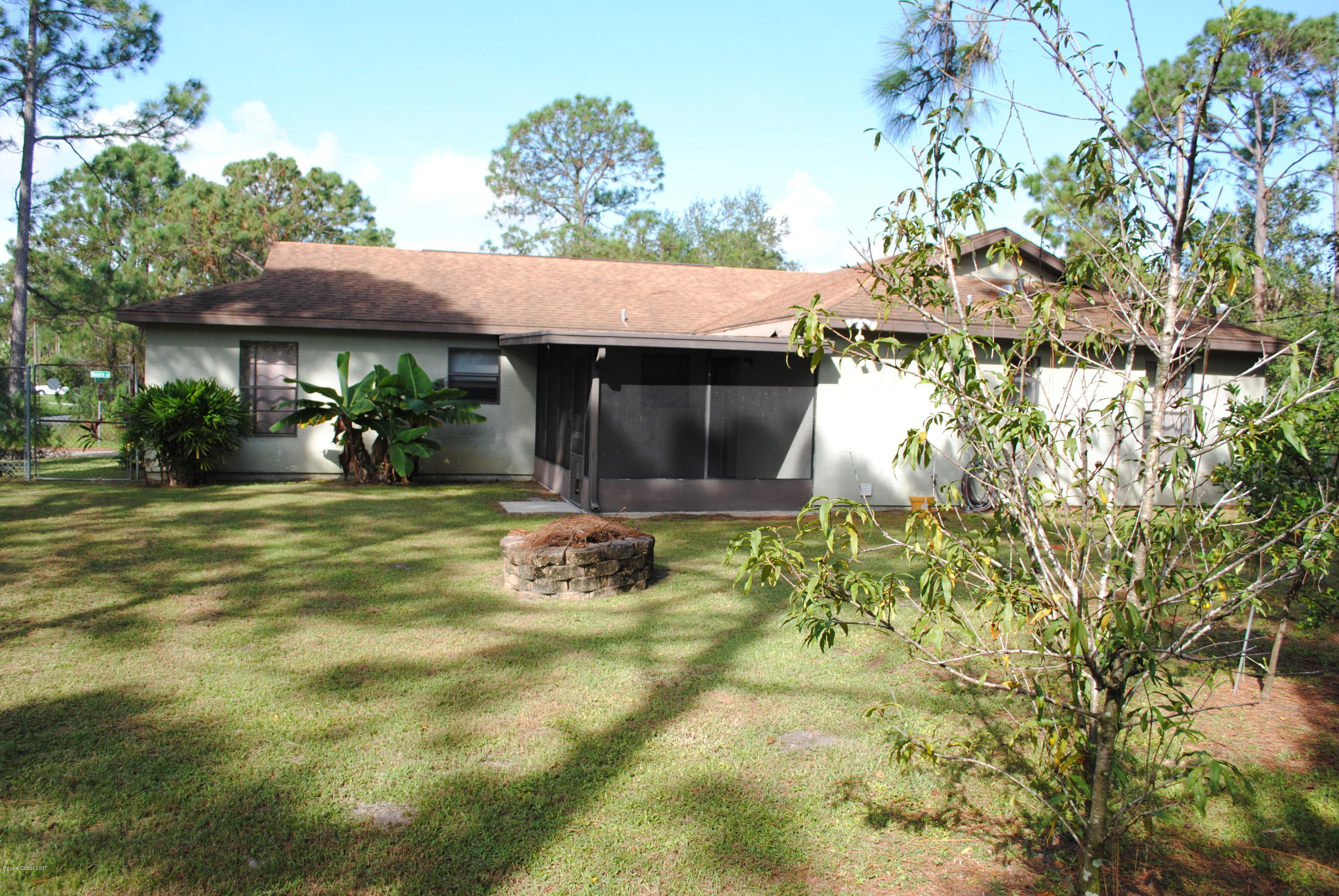 399 Warner Road Southwest Palm Bay, FL 32908 - Photo 37 of 40 a view of a house with a yard