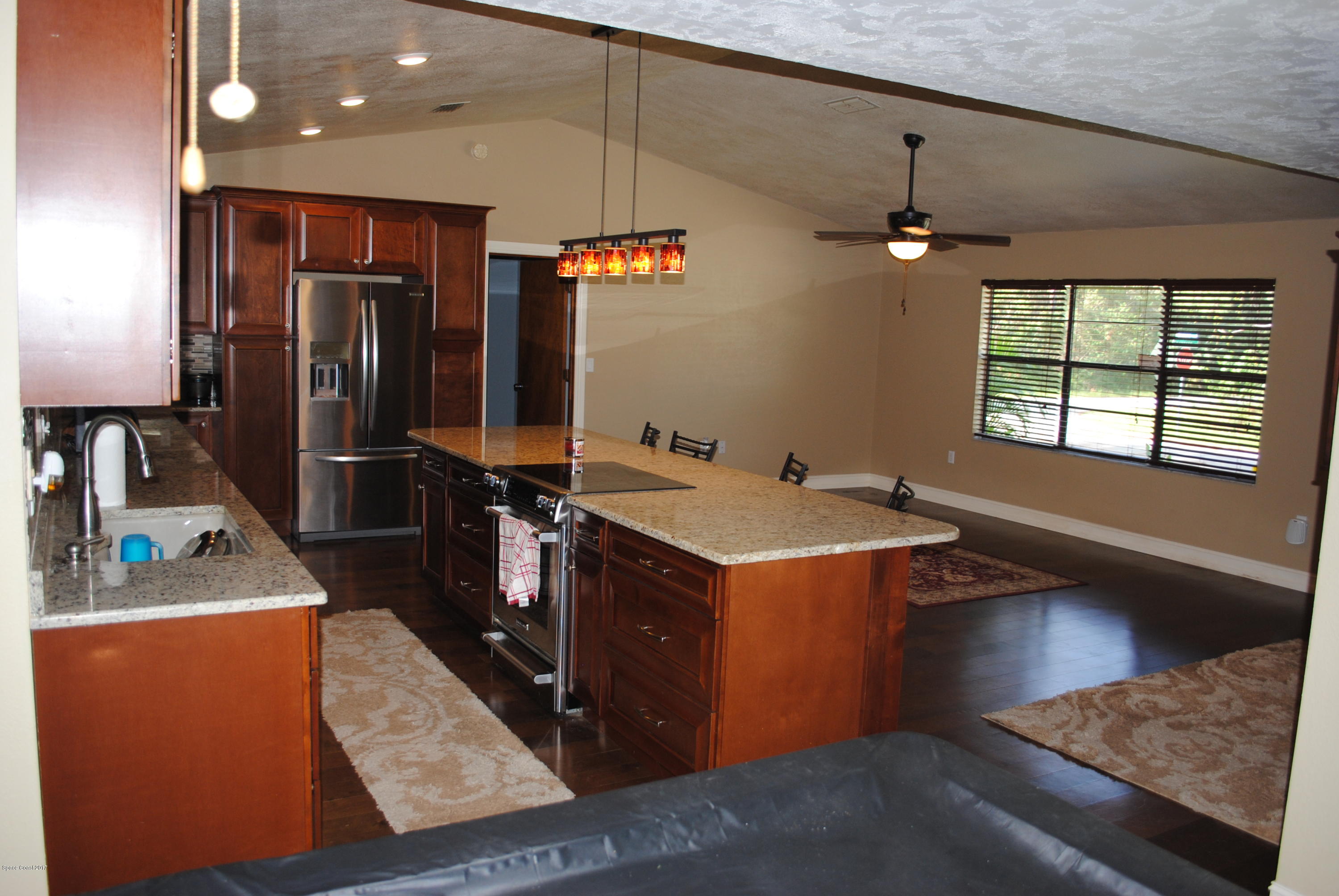 399 Warner Road Southwest Palm Bay, FL 32908 - Photo 7 of 40 a kitchen with a stove a refrigerator and a stove