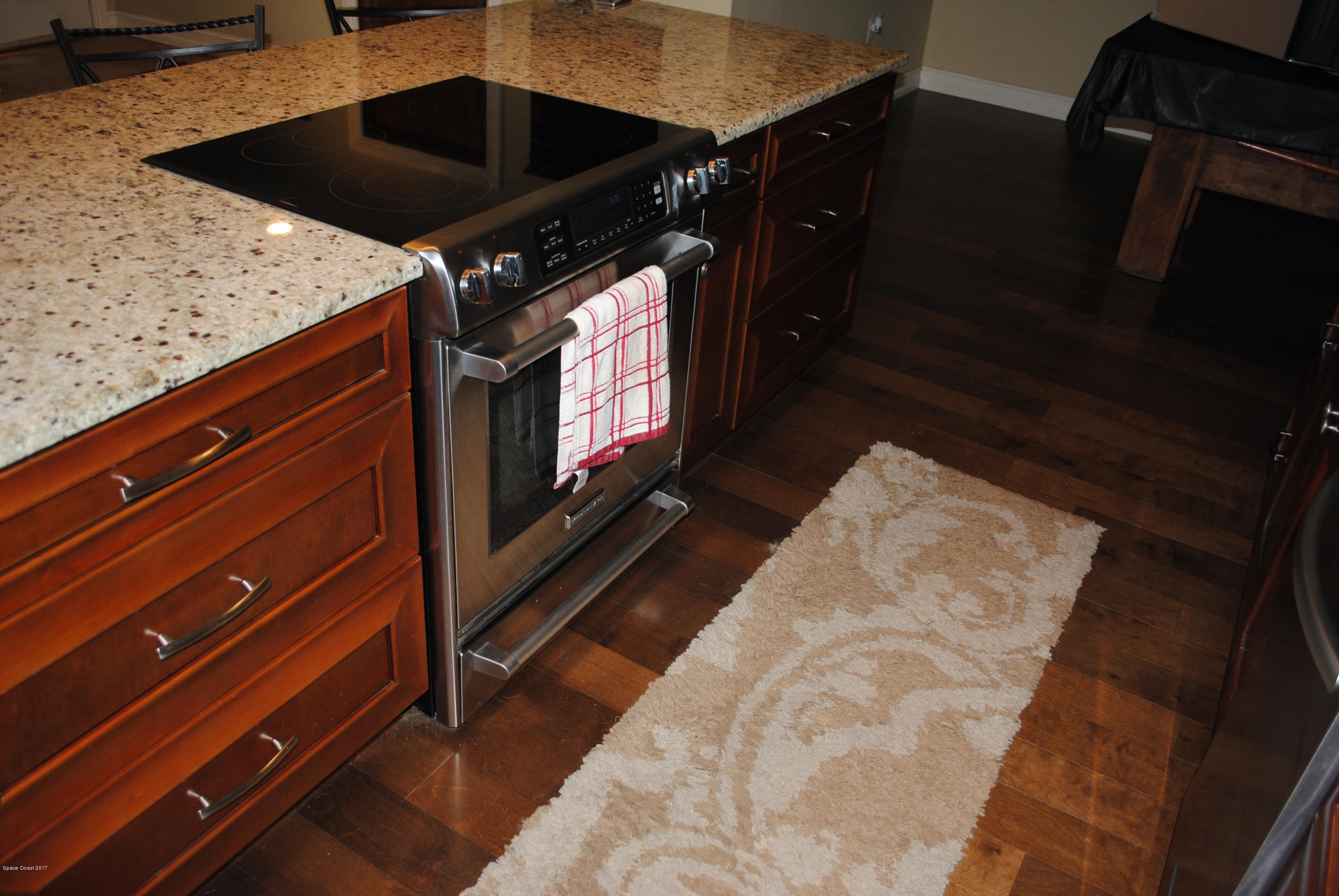 399 Warner Road Southwest Palm Bay, FL 32908 - Photo 8 of 40 a view of kitchen island with wooden floor