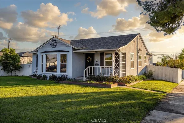 a view of a house with a swimming pool and a yard