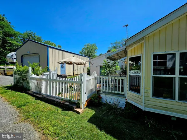 a view of house with backyard and sitting area