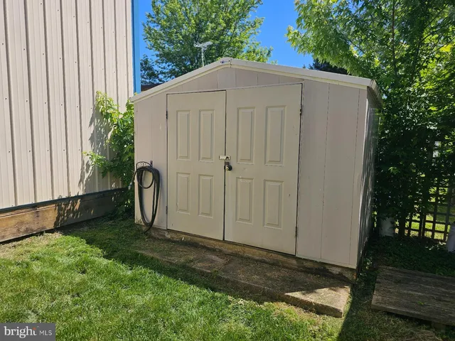 a backyard of a house with plants and tree