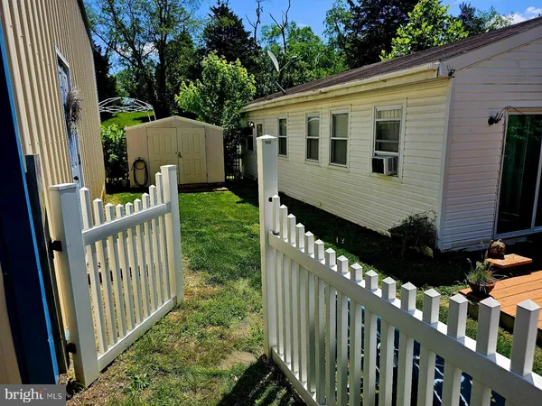 a view of a house with backyard and porch