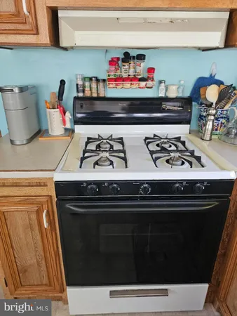 a stove top oven sitting inside of a kitchen