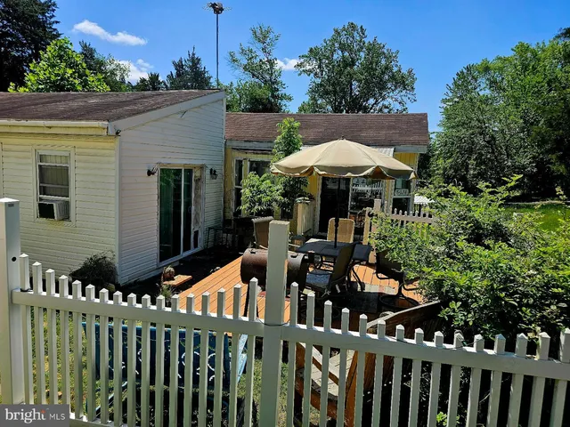 a view of a chairs and tables under an umbrella