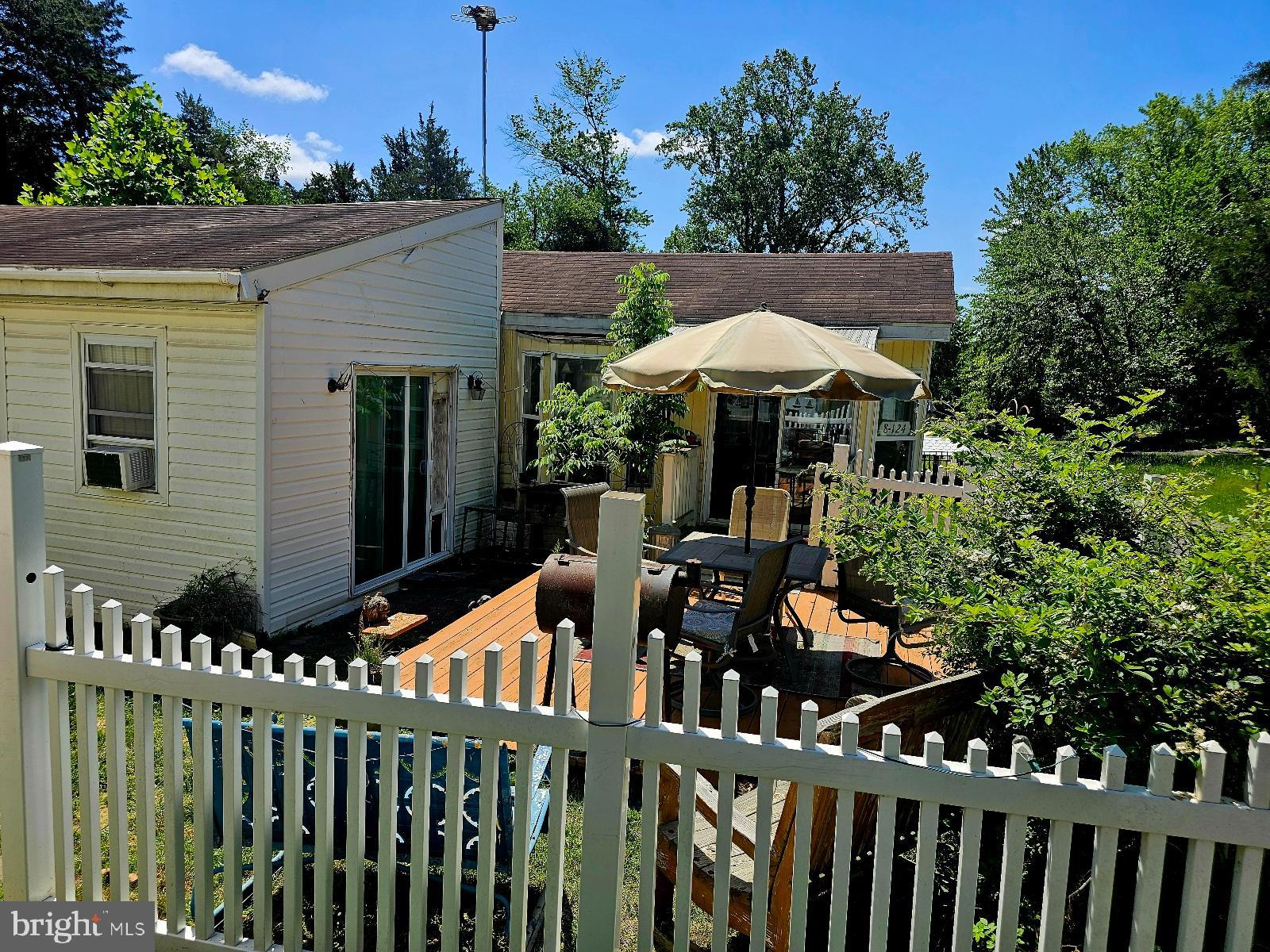 123-124 Palute Circle, Unit GLEN 8 Earleville, MD 21919 - Photo 34 of 40 a view of a chairs and tables under an umbrella