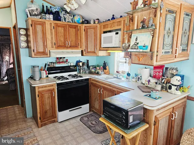 a kitchen with stainless steel appliances granite countertop a stove and a sink