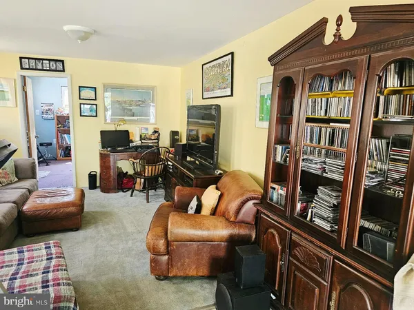 a living room with furniture fireplace and a window