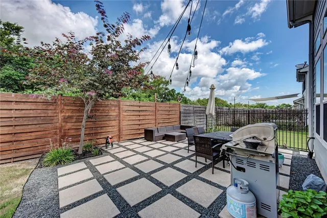a view of a patio with table and chairs and potted plants