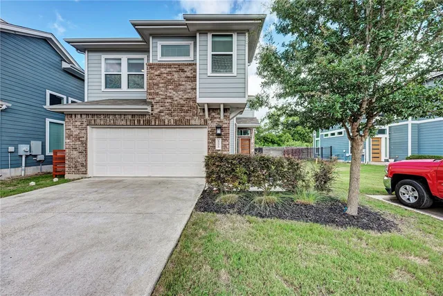 a view of a house that has a car parked in front of it