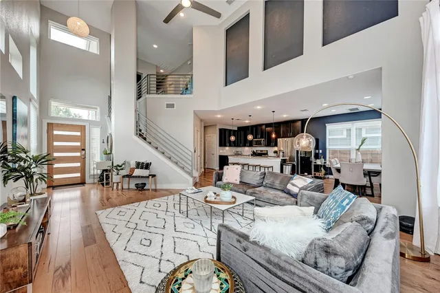 a living room with furniture and wooden floor
