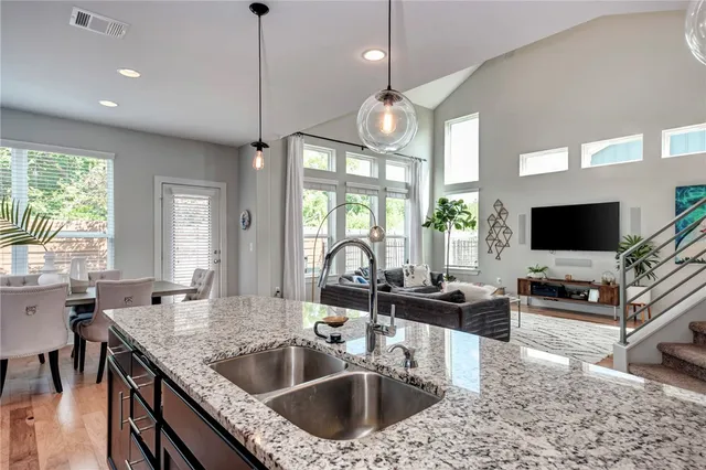 a kitchen with granite countertop a sink and a stove