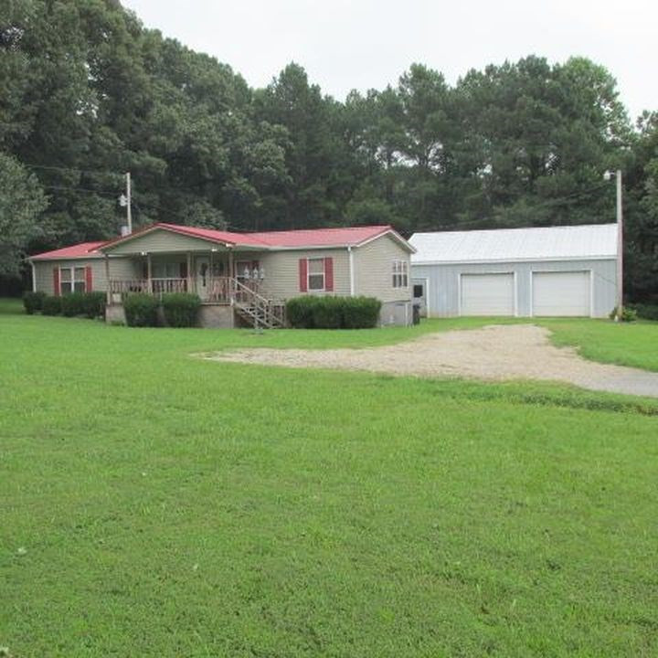 1610 Fesmire Road Cedar Grove, TN 38321 - Photo 1 of 1 a front view of a house with a yard and trees