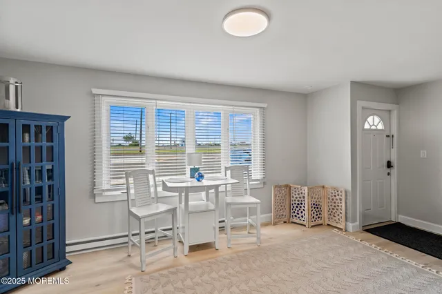 a view of a room with furniture and windows